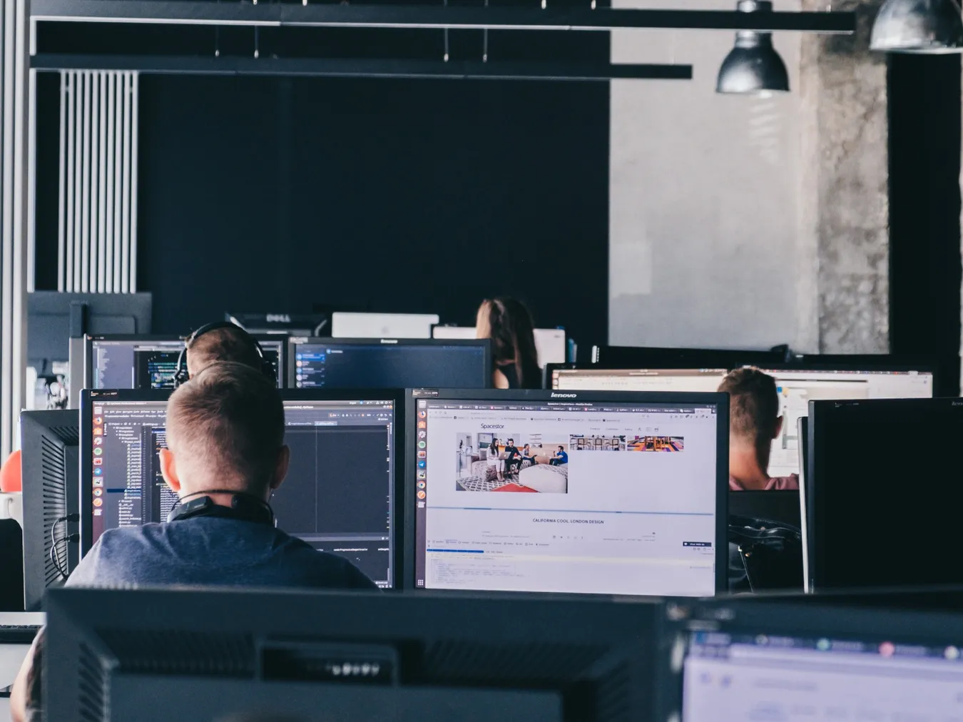 Order Group developers working at multi-monitor desks in an open-plan office