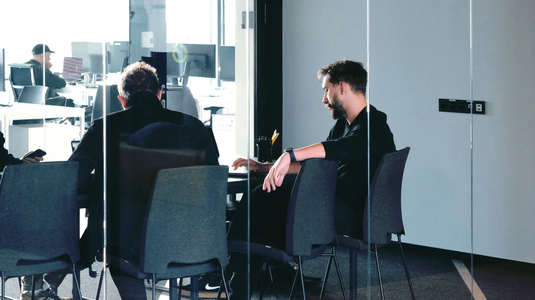 Business meeting in a glass-walled conference room