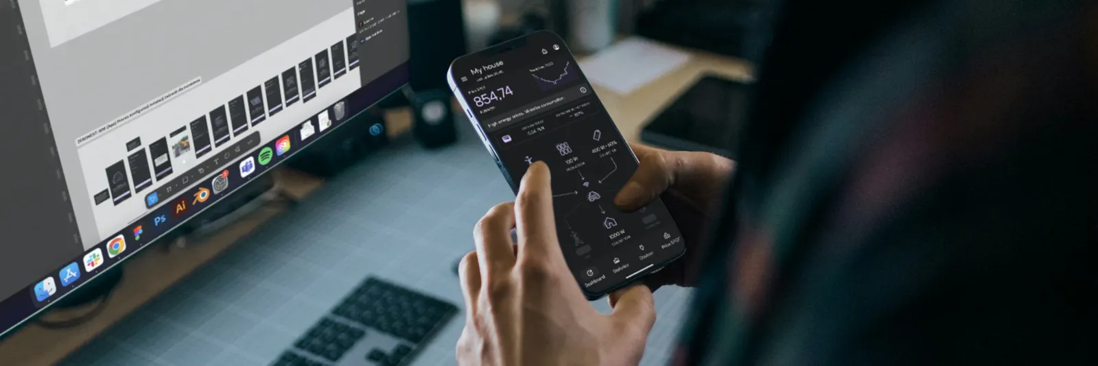 Designer working on mobile app UI in Figma with energy management app on smartphone