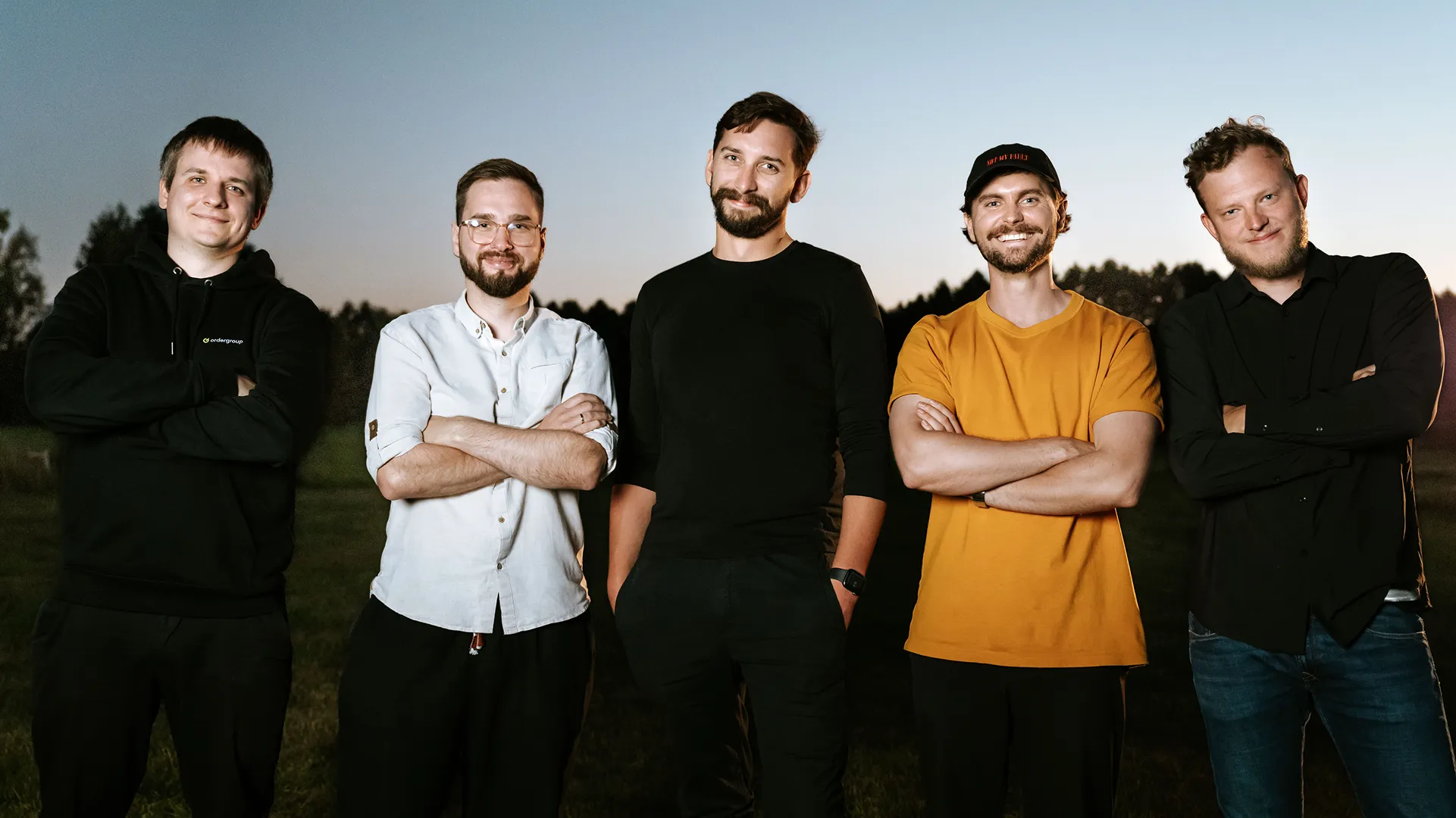 The five co-founders of Order Group outdoors at dusk