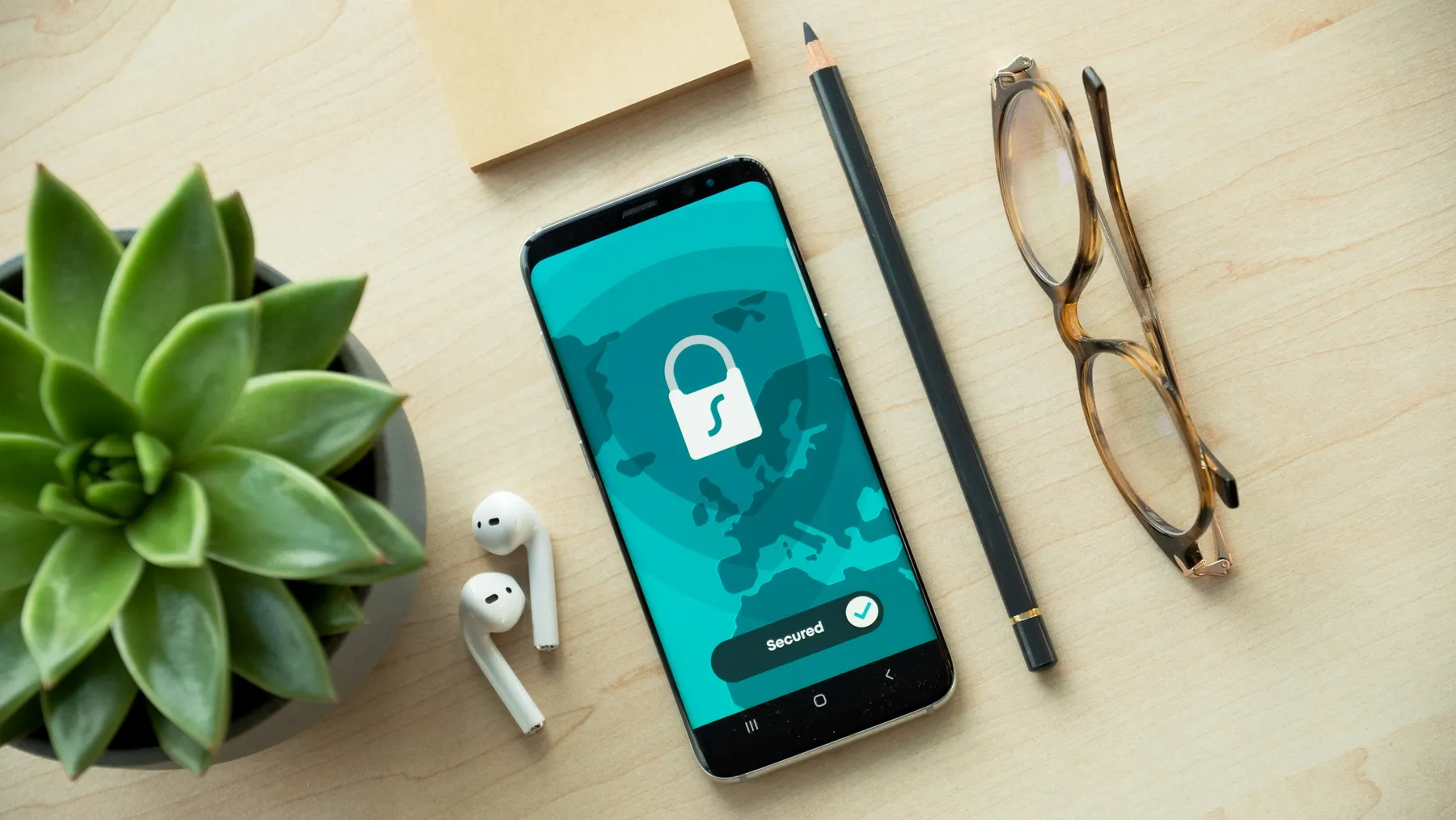Smartphone with a padlock security screen on a desk (Unsplash, Dan Nelson)