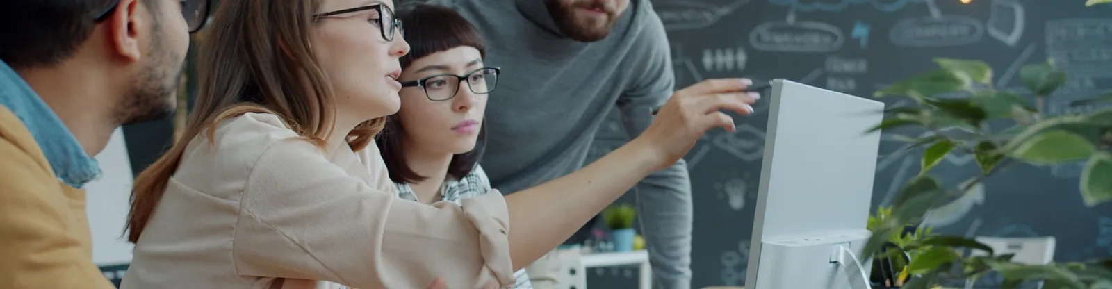 Design team reviewing a UI on screen (Unsplash)
