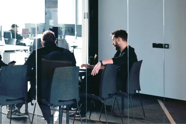 Business meeting in a glass-walled conference room